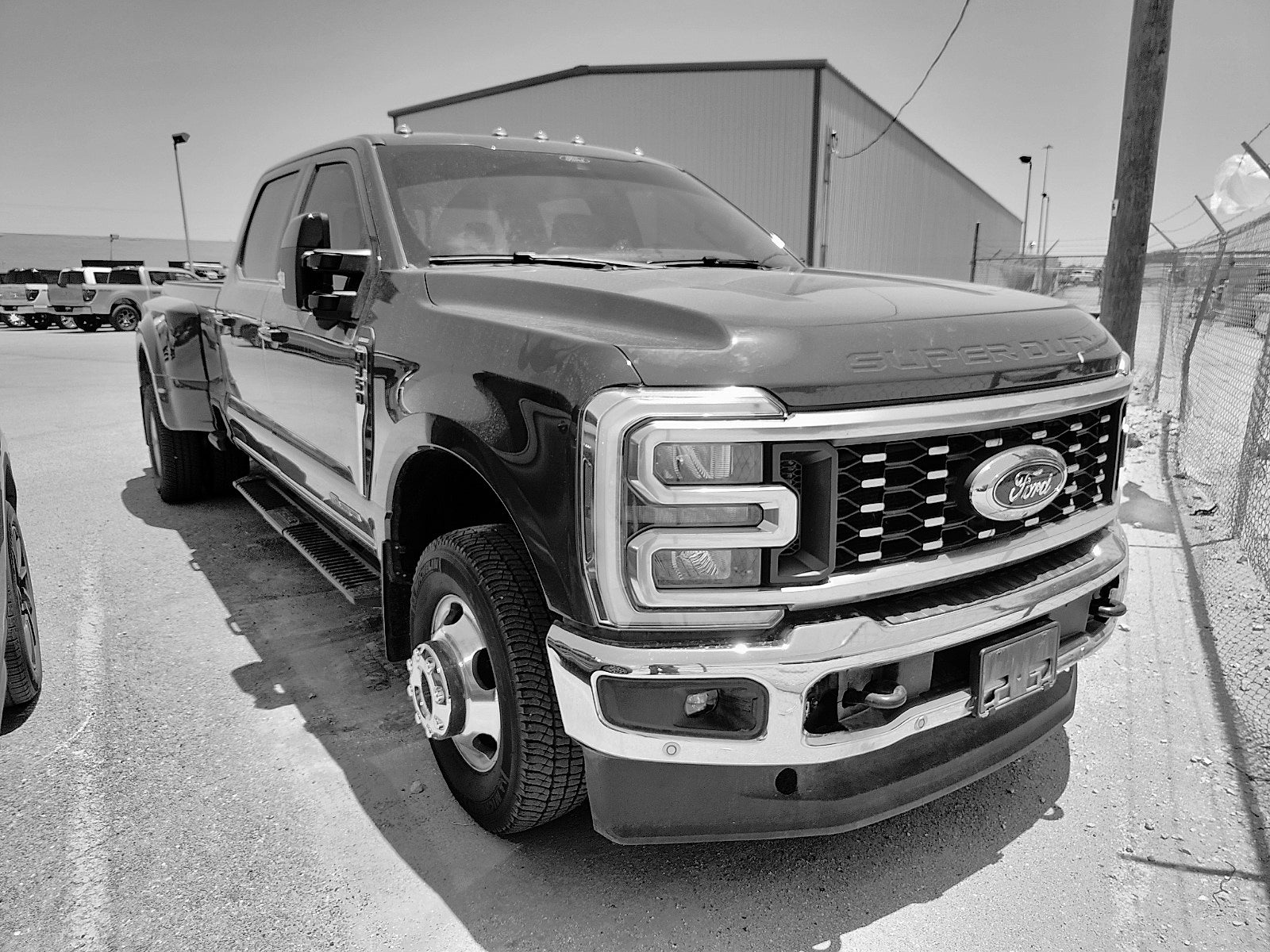 2026 Ford Super Duty F-350 DRW LARIAT in Ruby Red Metallic Tinted Clearcoat — front three-quarter view